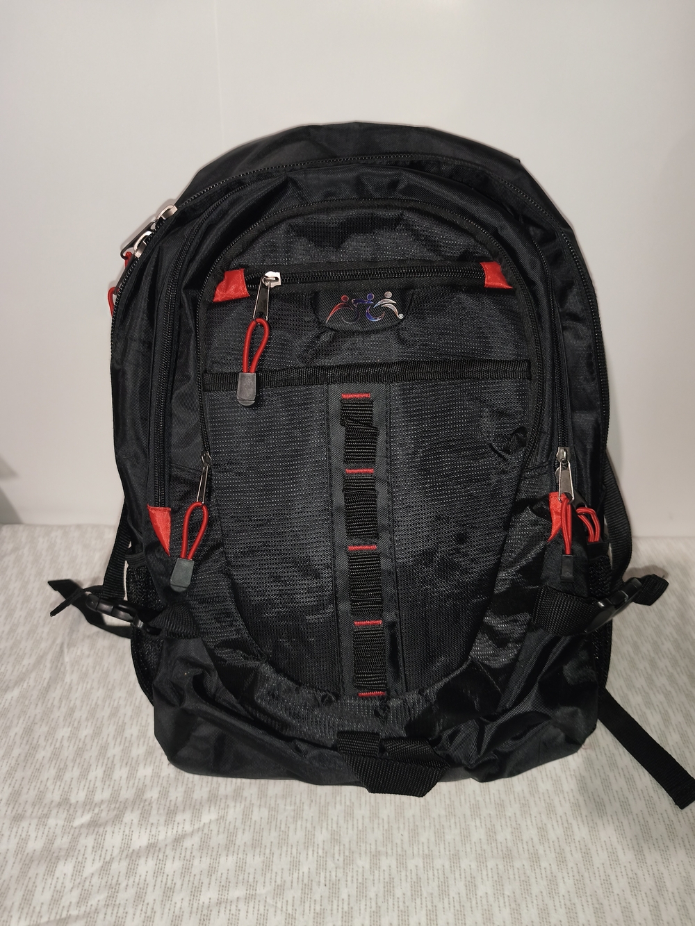 black and red  backpack is made from waterproof material and features...